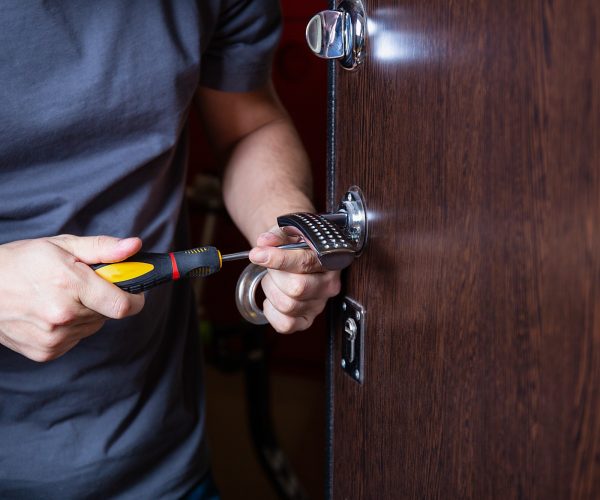 Locksmith replacing door lock to new after losing keys. Robbery protection
